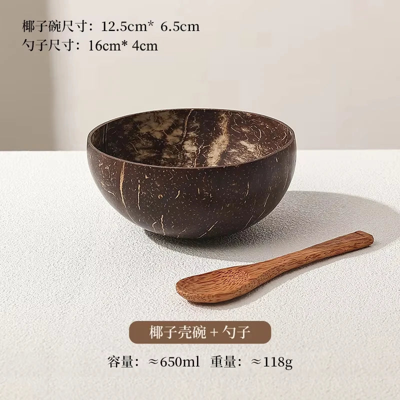 A set of natural wooden coconut bowls and a wooden spoon shown on a white surface.
