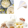 A collection of baking ingredients including butter, flour, and liquids shown with a measuring funnel pitcher.