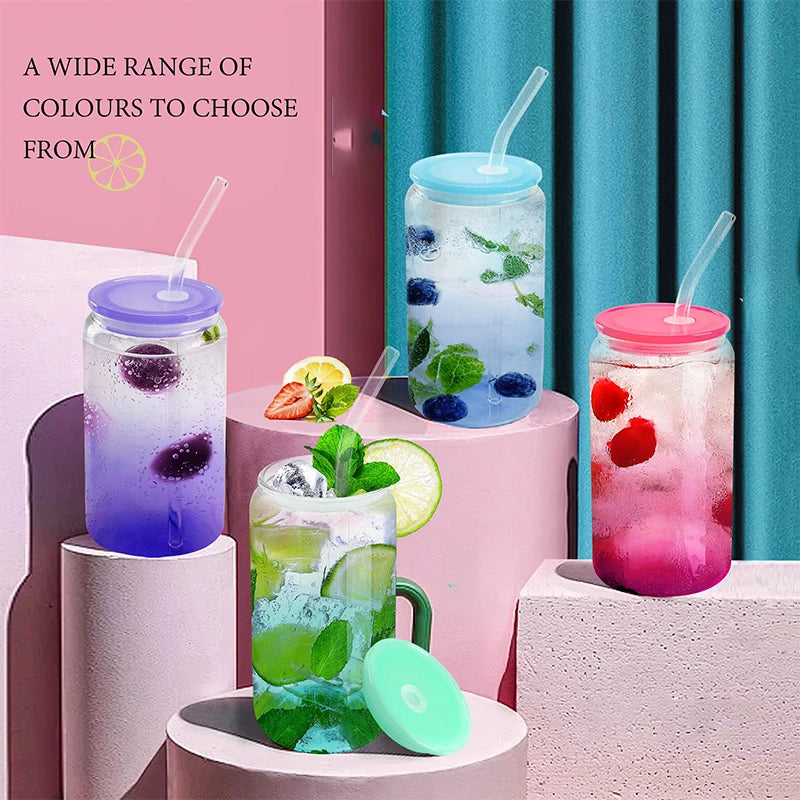A variety of colorful glass cups filled with ice and fruit, featuring bamboo lids and straws.