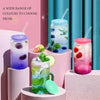A variety of colorful glass cups filled with ice and fruit, featuring bamboo lids and straws.
