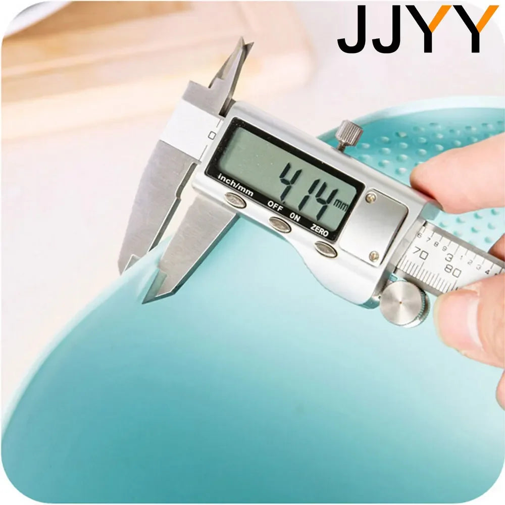 A hand holds a silver kitchen drainer colander with a digital scale displaying 4.14 mm.