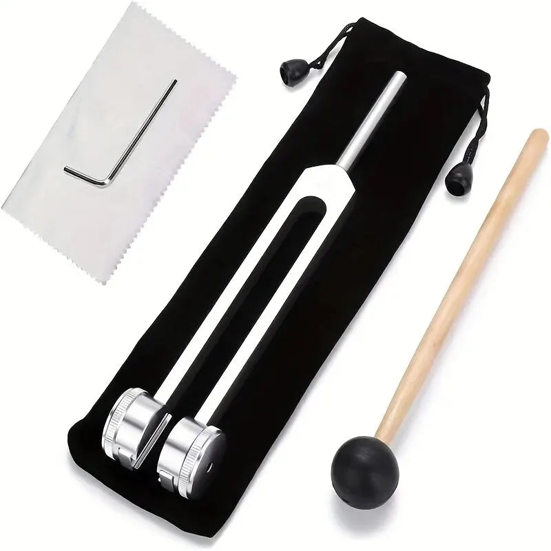 A set of tuning forks used for bio-acoustic tuning and healing, including a metal fork and a wooden mallet.