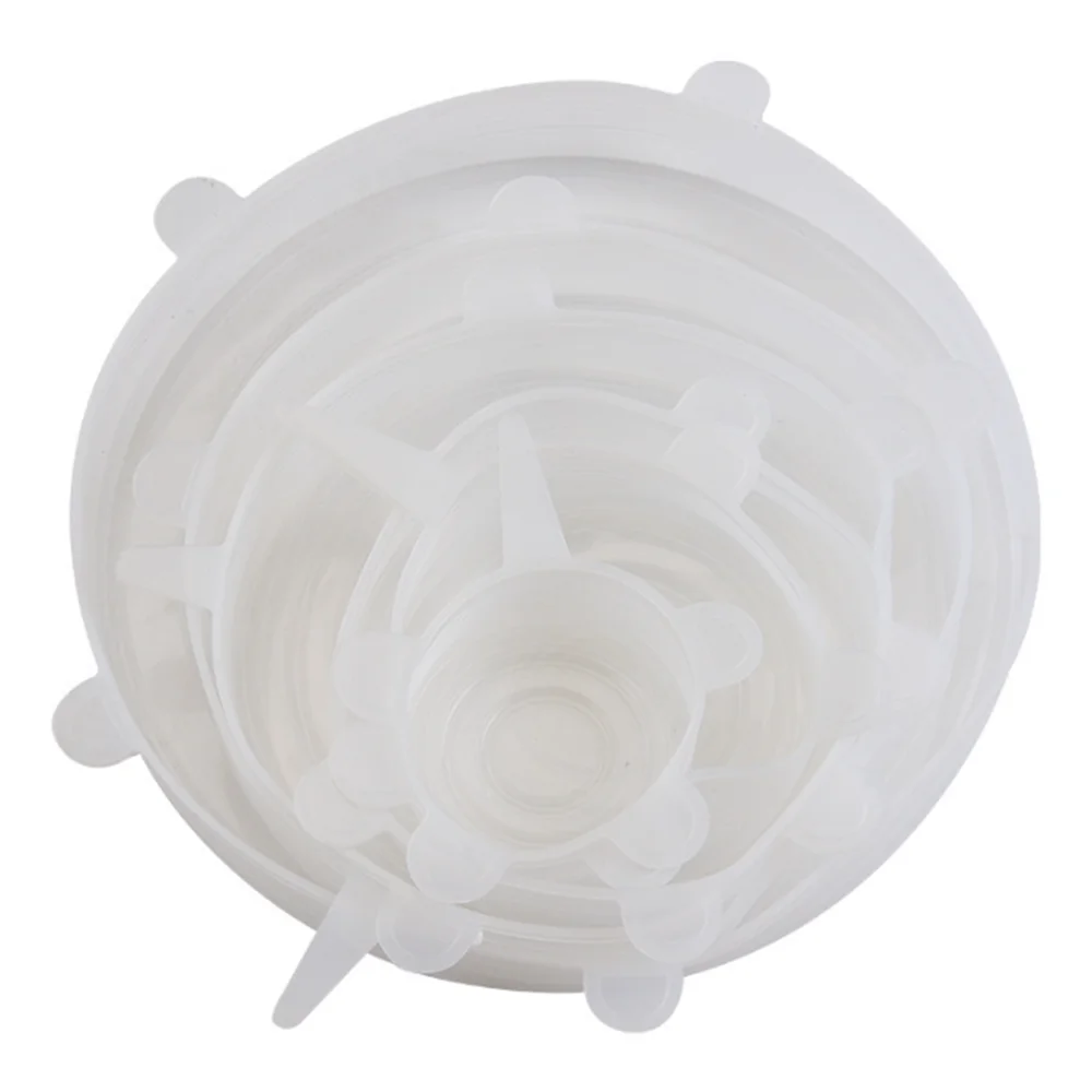 A clear reusable silicone food lids set with multiple circular lids stacked on a white background.