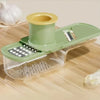 A green and yellow 3-in-1 multifunctional grinder for ginger and garlic is shown on a wooden surface.