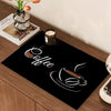 A black mat featuring a white line drawing of a coffee cup and steam on a wooden surface.