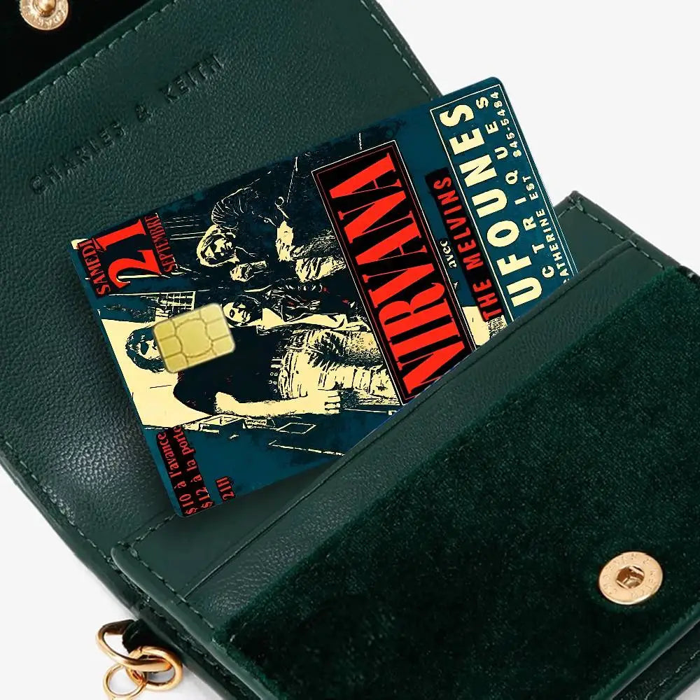 A dark green wallet features a debit card with Nirvana band anime stickers.