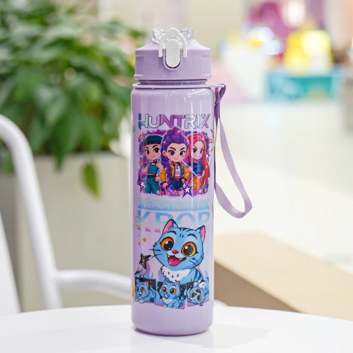 A purple insulated water bottle featuring a cartoon print of characters from Demon Knights.