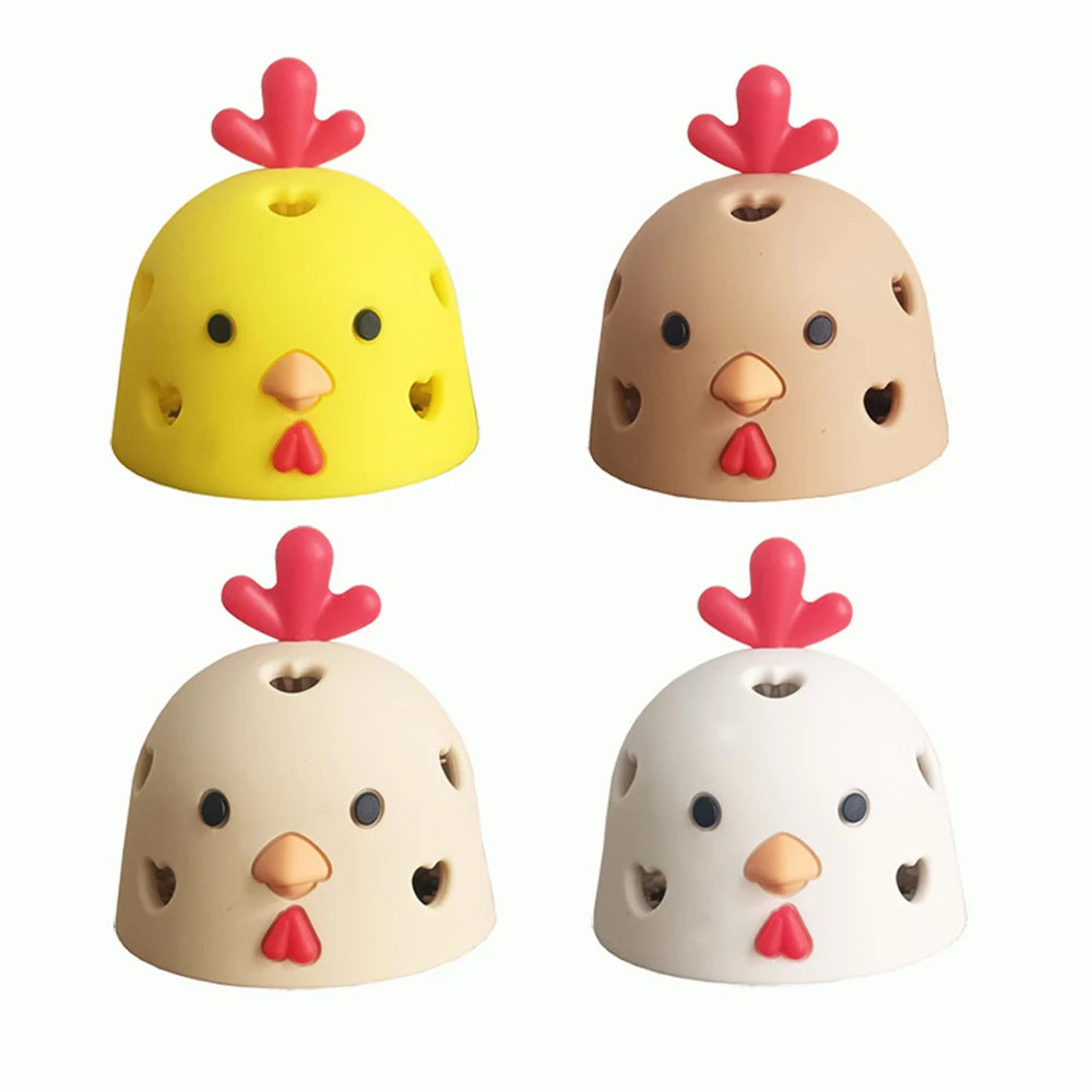 A set of four silicone egg cleaning brushes shaped like yellow, beige, and white chicks.