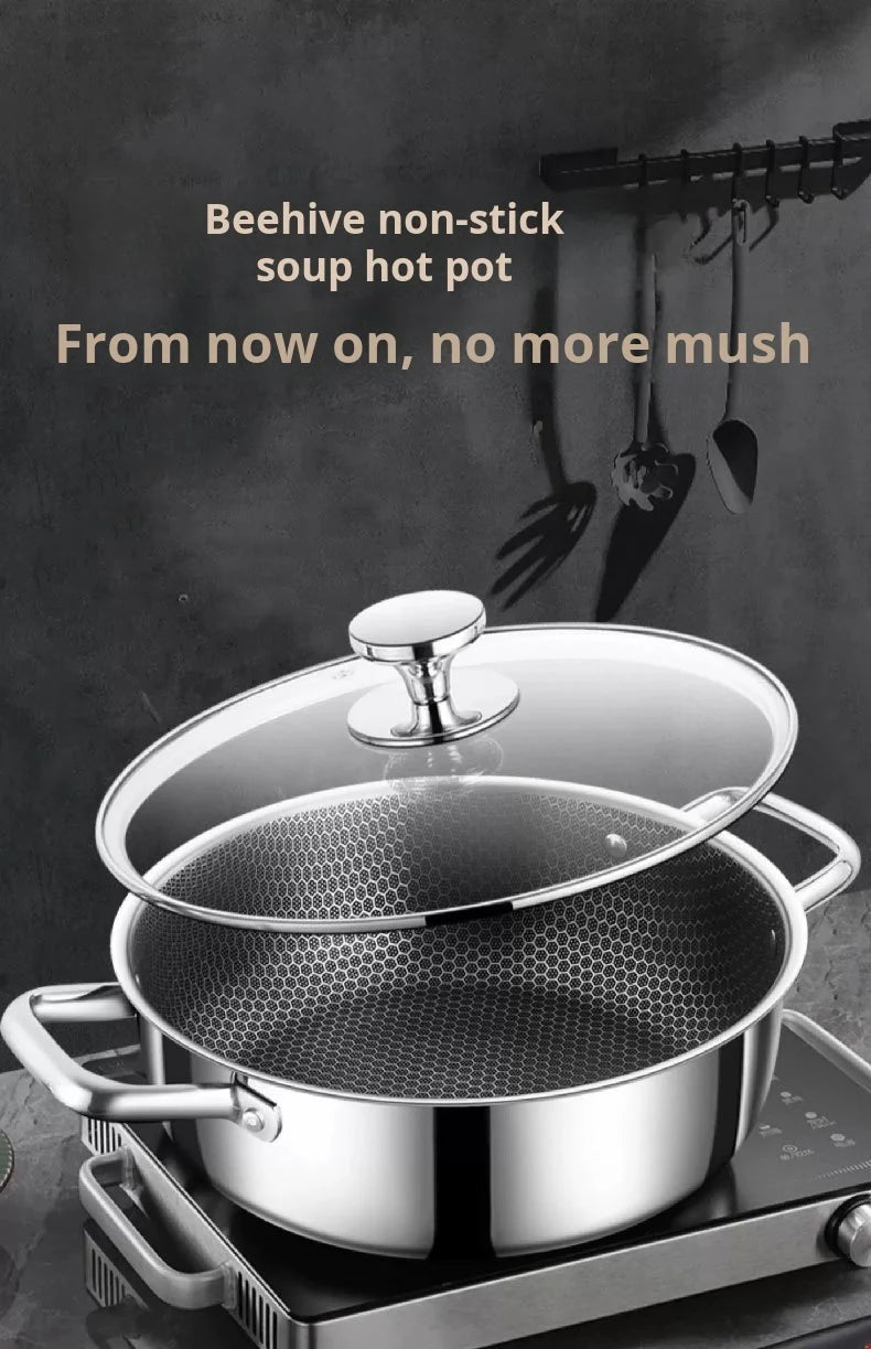 A silver beehive non-stick soup hot pot with a glass lid resting on a stovetop.