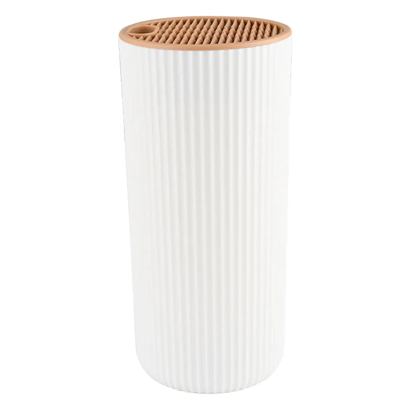 A white cylindrical knife block organizer with a wooden top and ribbed body.