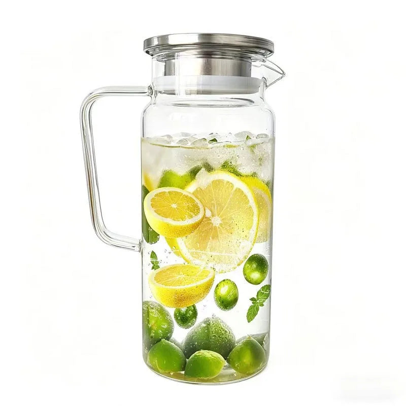 A clear glass water jug with a metal lid filled with water, lemon slices, and mint leaves.