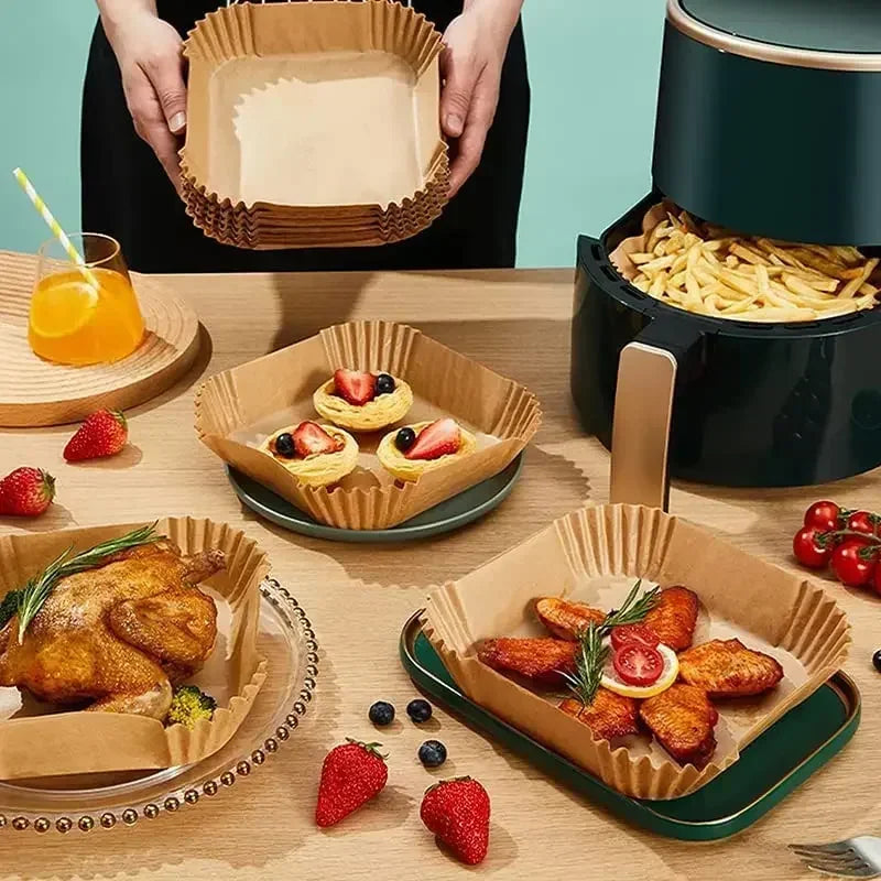 A serving of roasted chicken pieces in a disposable paper liner with fresh fruit and vegetables.