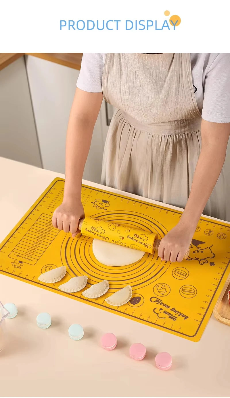 A person is using a silicone rolling pin and baking mat set on a light-colored surface.