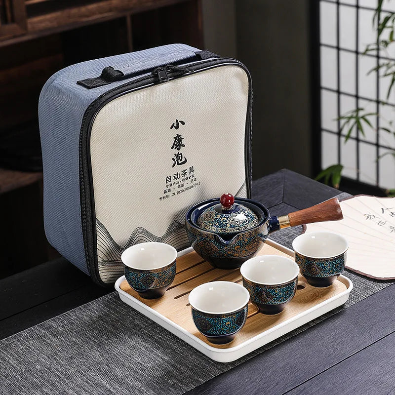 A light blue fabric pouch containing a traditional Kung Fu ceramic tea set with a wooden tray and white cups.