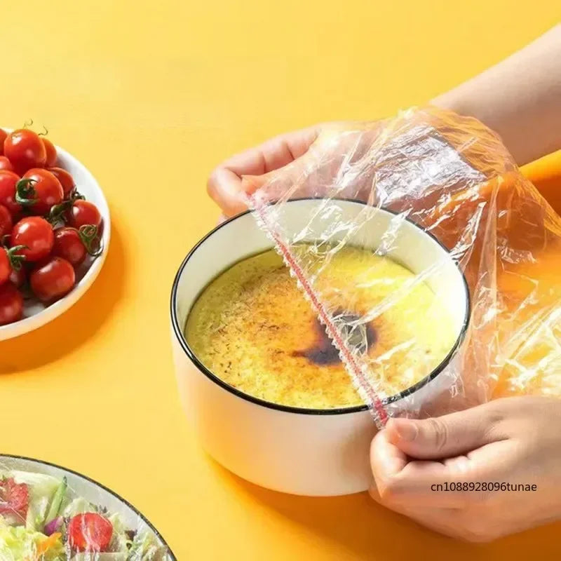 Hands are holding a reusable food storage bag over a bowl of yellow soup or broth on a bright yellow background.