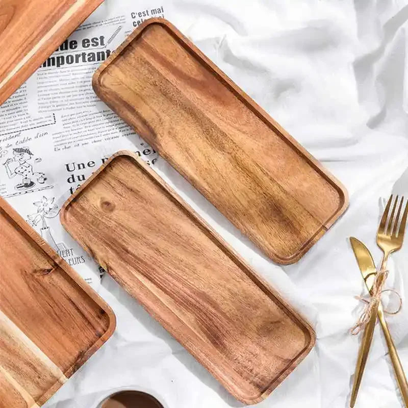 Two rectangular serving trays made of natural acacia wood are displayed on white paper.