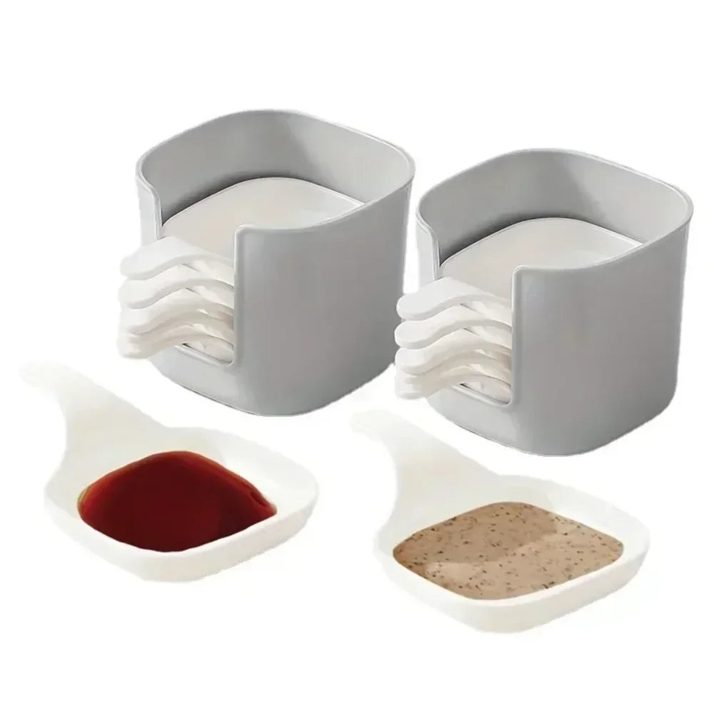 A set of seven plastic sauce dishes for seasoning and serving, including a main dish and several smaller spoons.