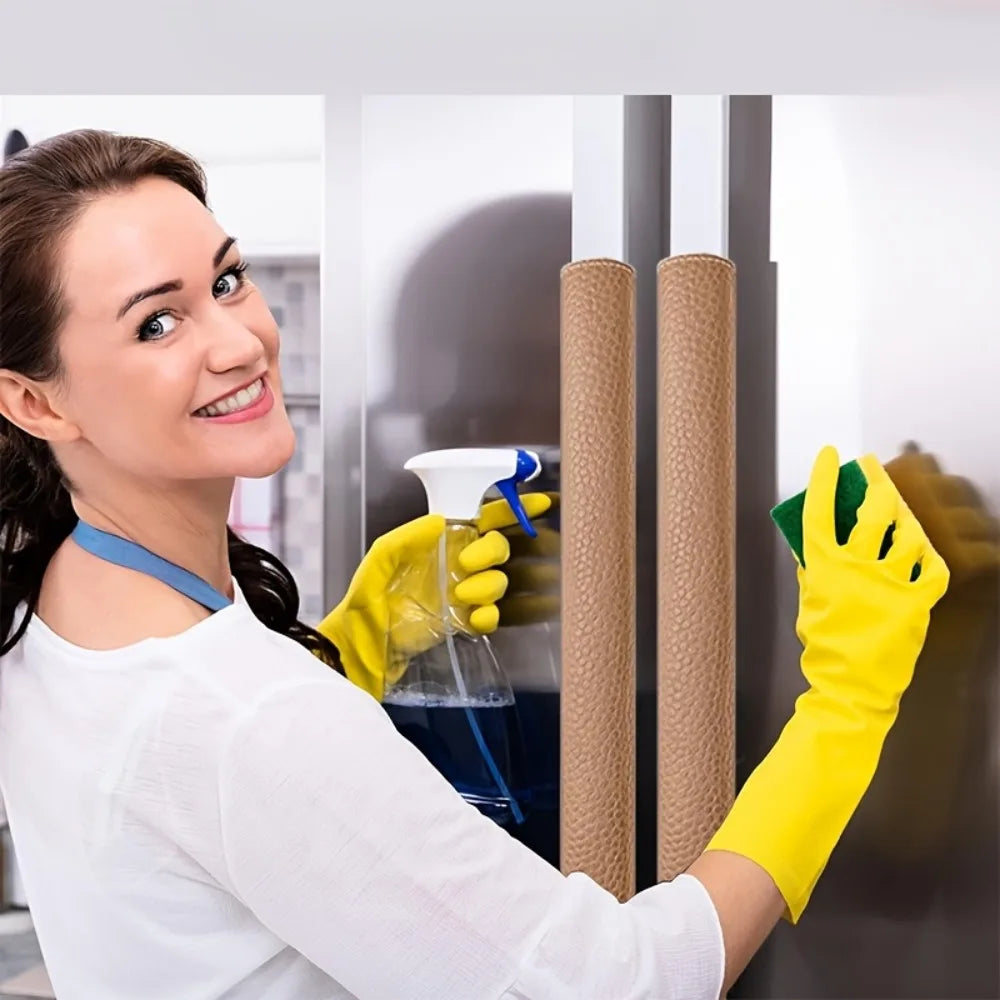 A woman wearing a white shirt and yellow gloves is installing faux leather refrigerator door handle covers on a cabinet.