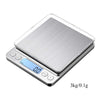 A silver digital kitchen scale with a glass platform displaying 0.0 and marked for 3kg/0.1g measurement.
