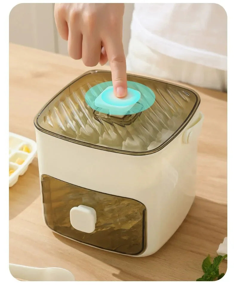 A hand is pressing a translucent ice cube mold into a white and brown reusable grid ice cube storage container.