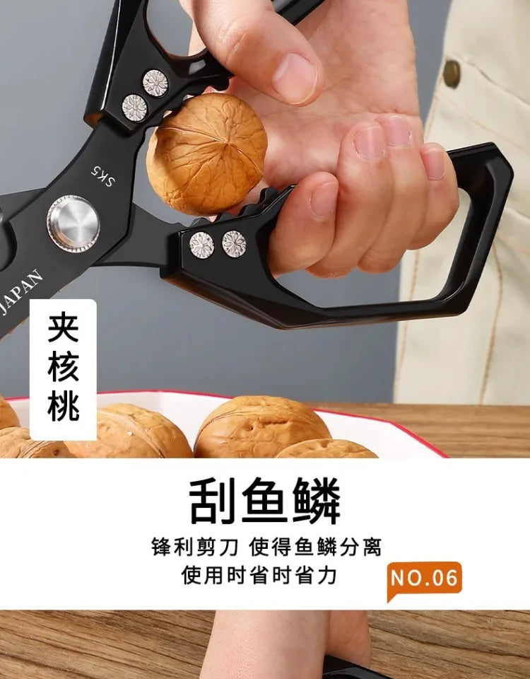 A hand is using professional titanium kitchen shears to cut a piece of meat.