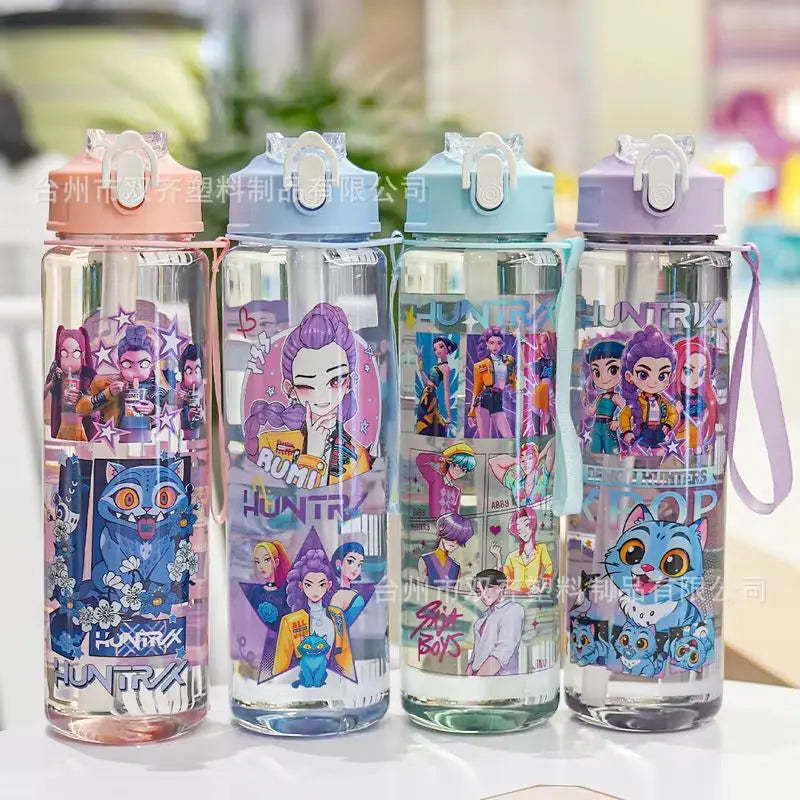 Four clear insulated water cups with colorful cartoon prints and pink lids arranged side by side