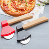 A red and black axe-shaped pizza cutter set resting on a light gray surface next to a pizza.