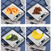 A precision digital kitchen scale displays various food items like bread, cinnamon sticks, and bananas.