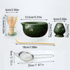 A set of matcha tools including a bamboo whisk, a green ceramic bowl, and a metal strainer.
