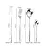 A set of four stainless steel flatware pieces including a knife, fork, spoon, and another spoon.