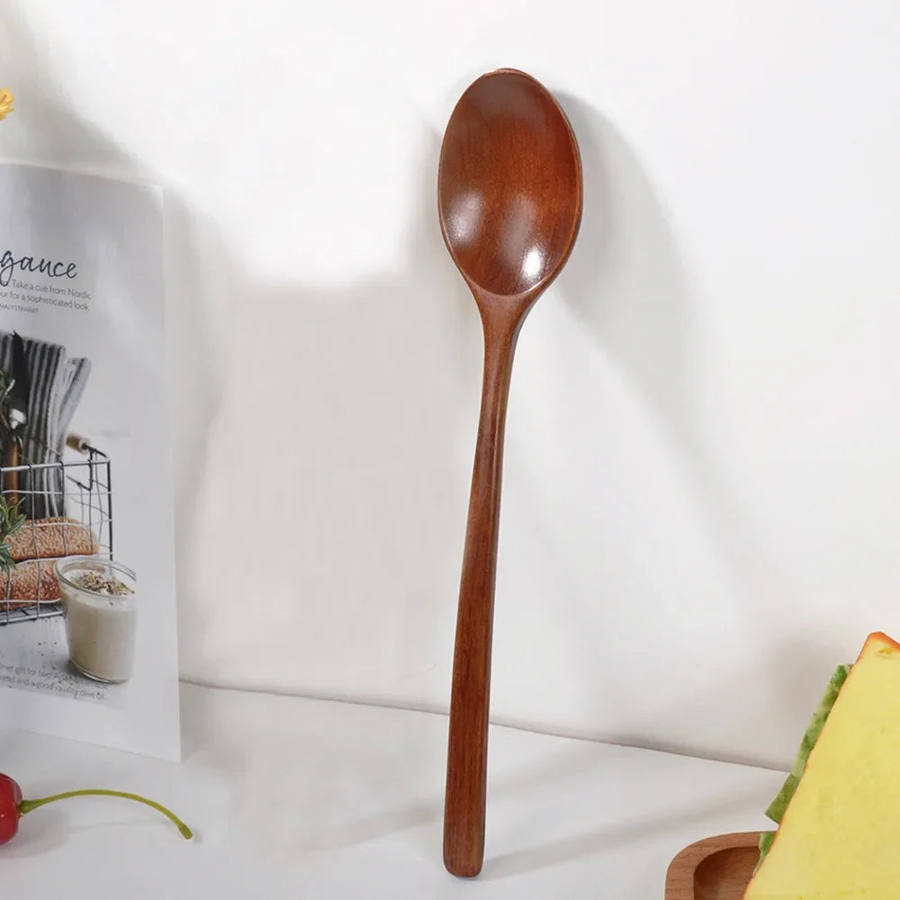 A single wooden spoon with a smooth handle is displayed against a white background.