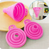 A set of pink silicone collapsible funnels shown in various forms, including a large funnel and disc shapes.