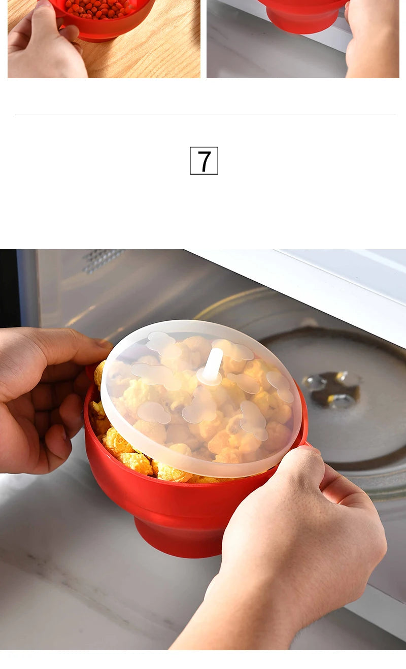 A hand is holding a red silicone microwave popcorn bowl filled with popped corn.