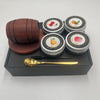 A set of six small tins containing whiskey smoker wood chips with various fruit flavors like cherry, lemon, and peach.