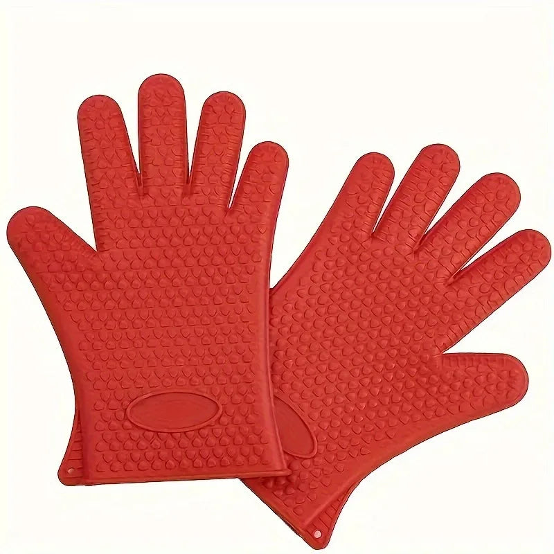 A pair of bright orange silicone heat resistant kitchen and BBQ gloves shown flat.