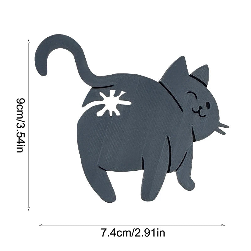 A gray wooden cat figurine with a visible paw print on its body.