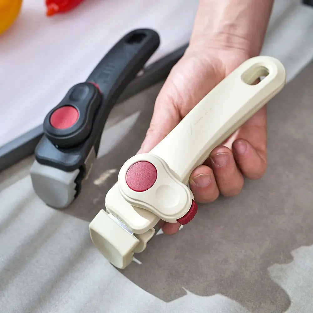 A hand holds a detachable cookware handle clip, showing its light beige and dark gray components.