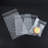 Several clear plastic bags with white dots are shown, containing a round cookie.