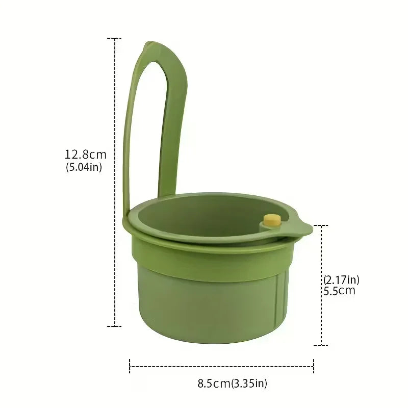A light green press-type drain basket with a handle, shown in a side view.