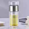 A clear double-layer borosilicate glass tea infuser with a silver cap and yellow liquid inside.