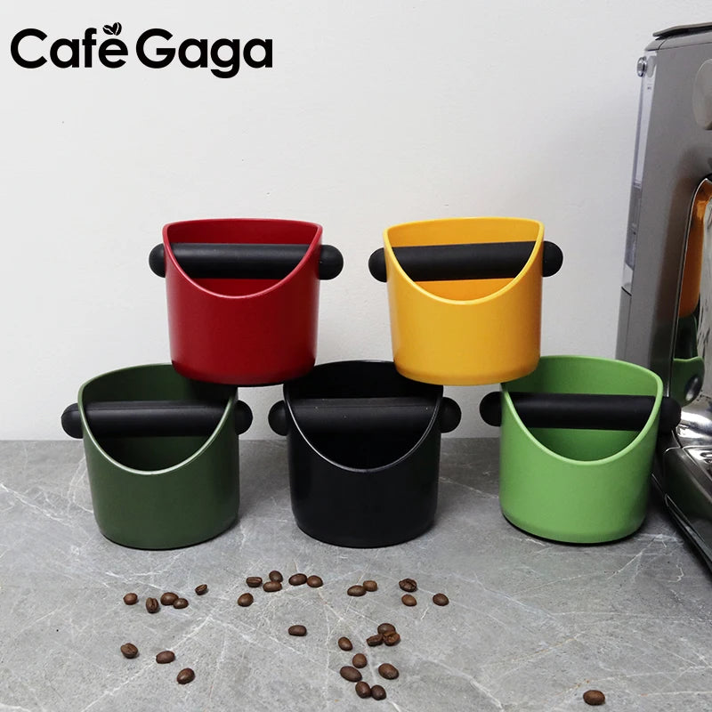 A set of four colored coffee grounds containers, including red, yellow, black, and green, displayed on a gray surface.