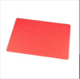 A rectangular silicone BBQ pizza mat or baking liner in bright coral pink.