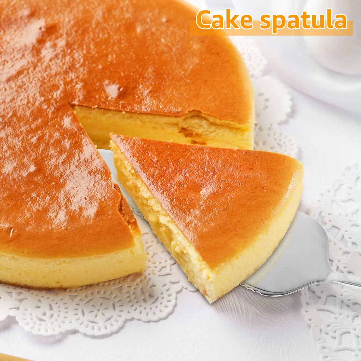 A slice of golden cake is shown next to a cake spatula on a white surface.