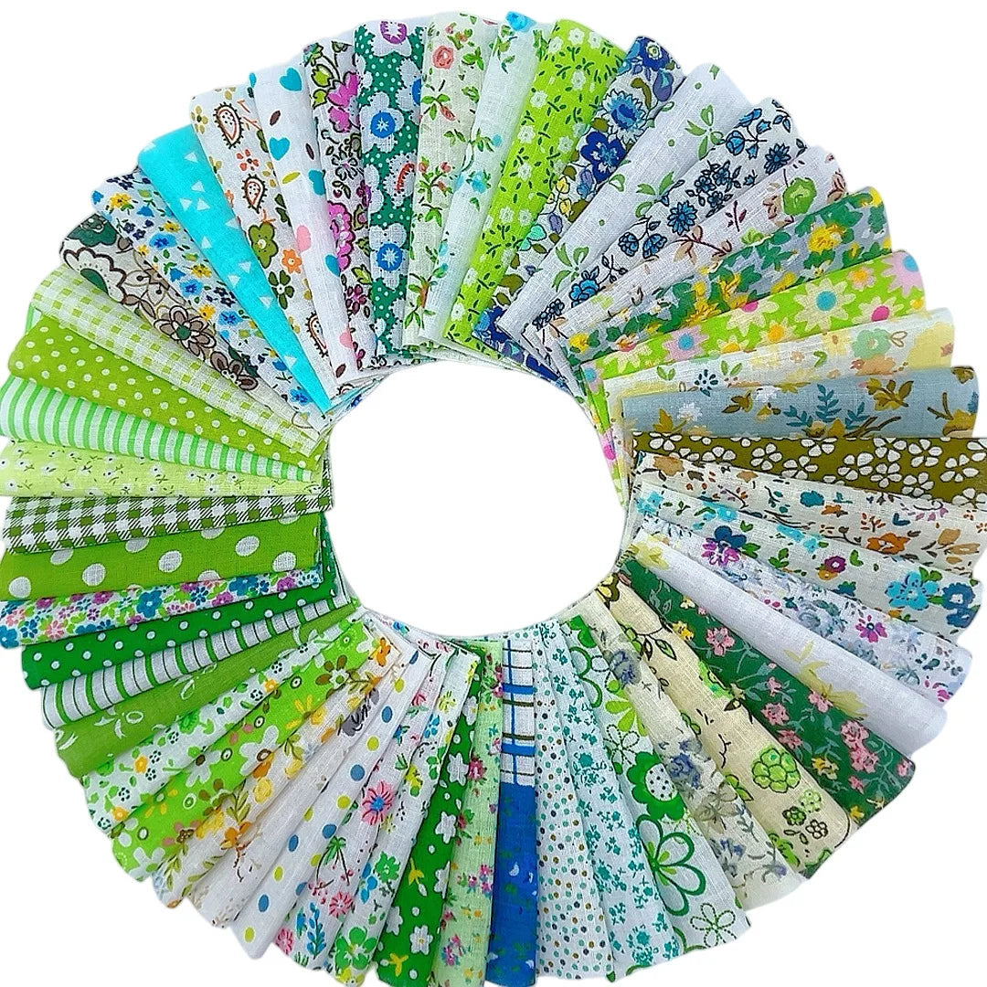 A circular display of various square printed cotton fabrics in shades of green, blue, and white.