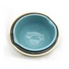 A light blue plastic salad bowl with a beige rim and dark gray interior.