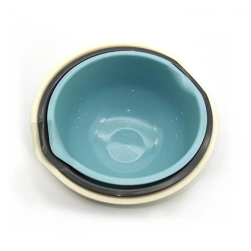 A light blue plastic salad bowl with a beige rim and dark gray interior.