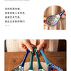 A set of colorful ceramic ladles with floral patterns resting on a woven mat.