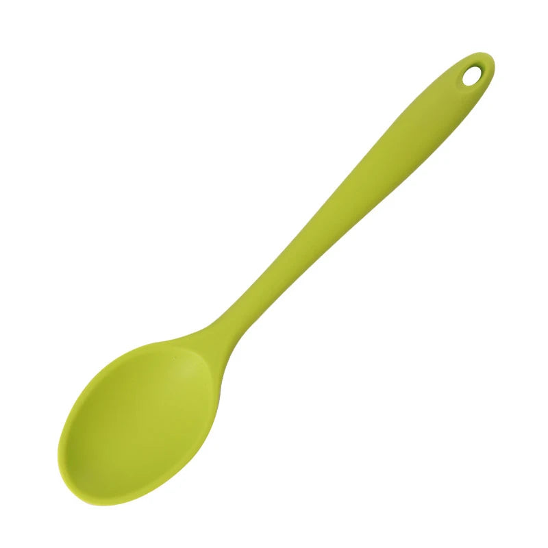A bright lime green silicone mixing spoon with a loop handle.