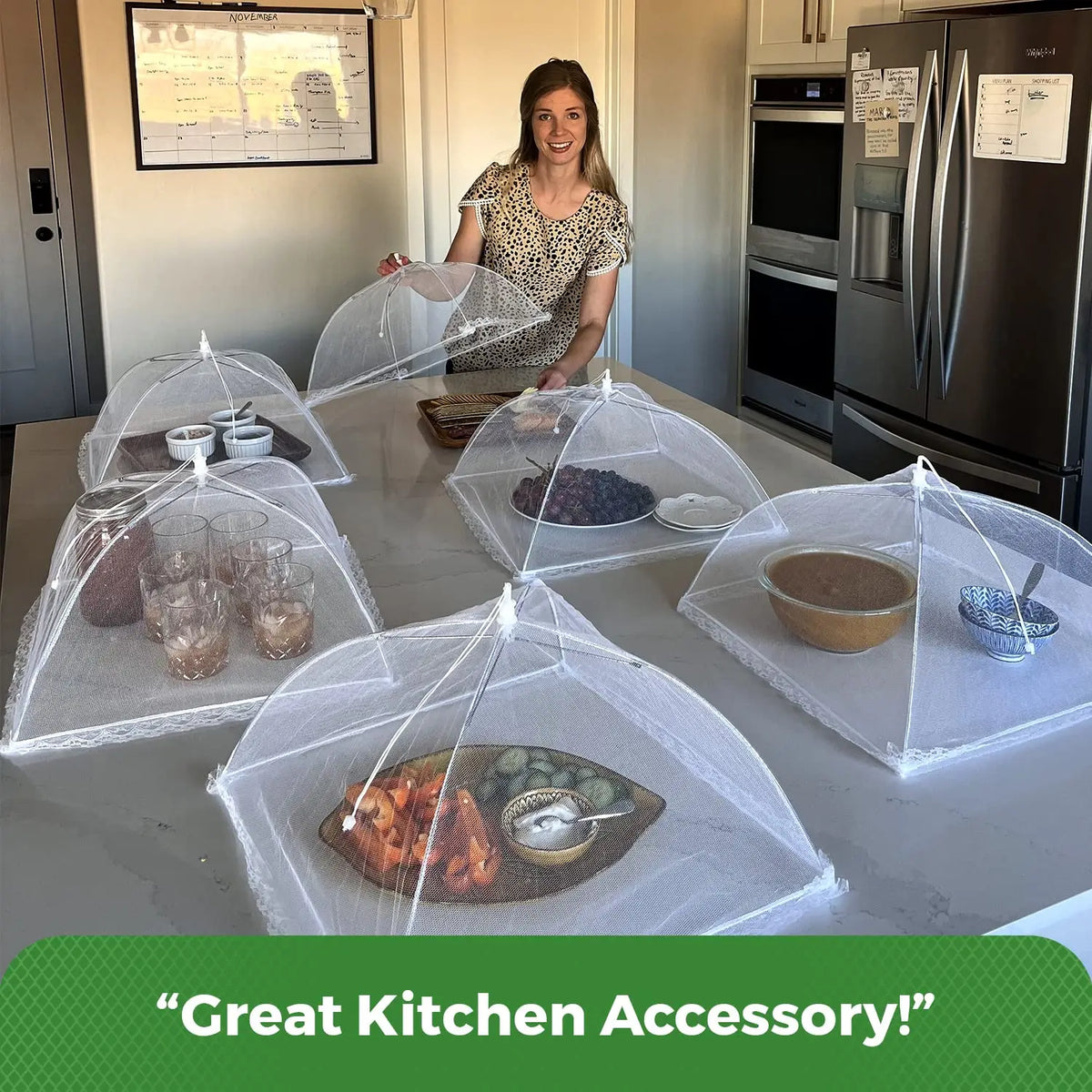 A clear mesh food and plant protection cover is displayed on a kitchen counter with various food items inside.