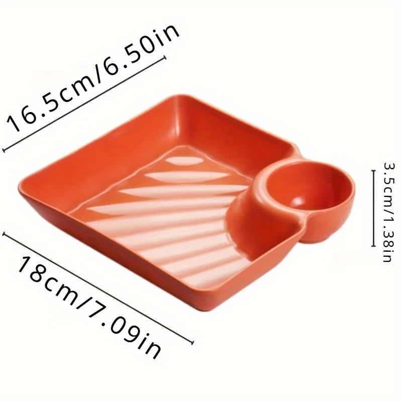 Orange serving plate with a divided section for appetizers or charcuterie.